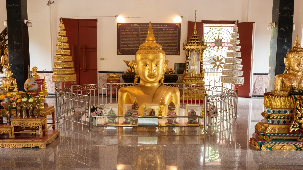 Half-buried golden Buddha statue at Wat Phra Thong