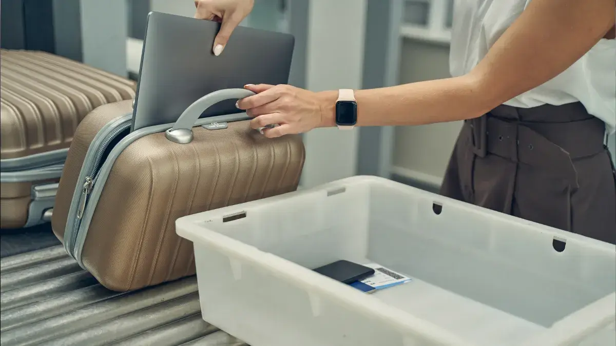 Removing laptop for airport security - Travel tech packing list 2026