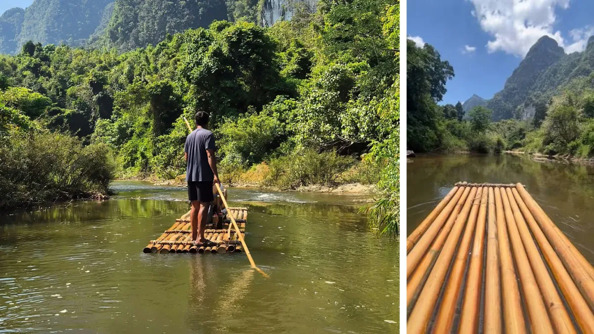 A person poles a bamboo raft down a calm river through lush mountains