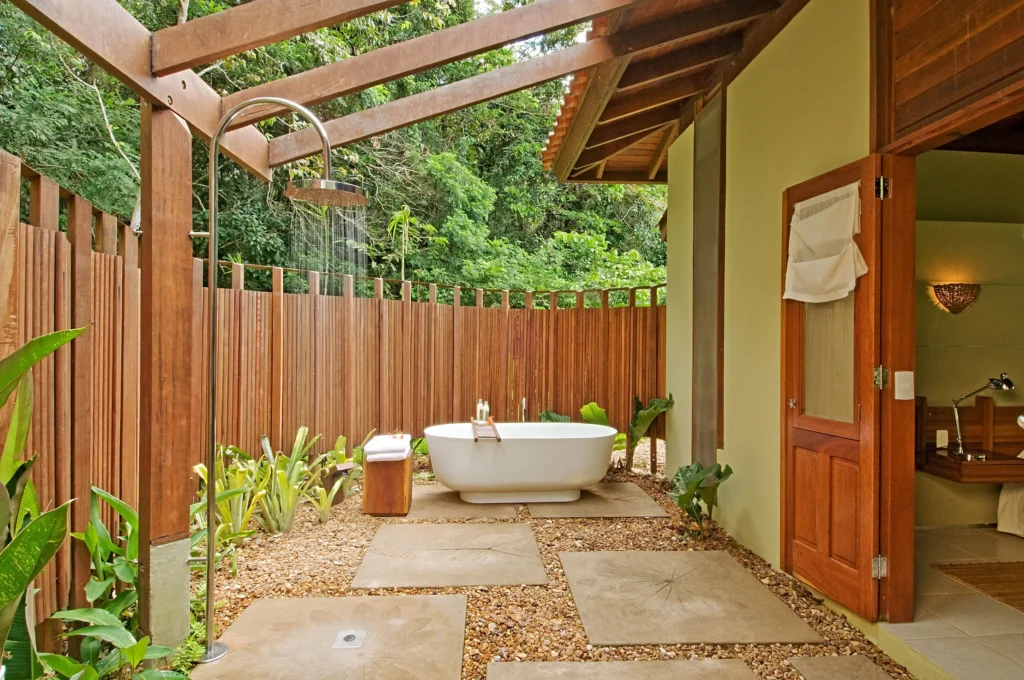 Outdoor bathtub and shower in a private tropical courtyard
