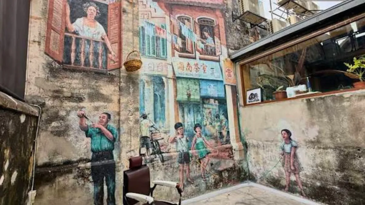 Mural of people on a weathered building wall in a narrow alley