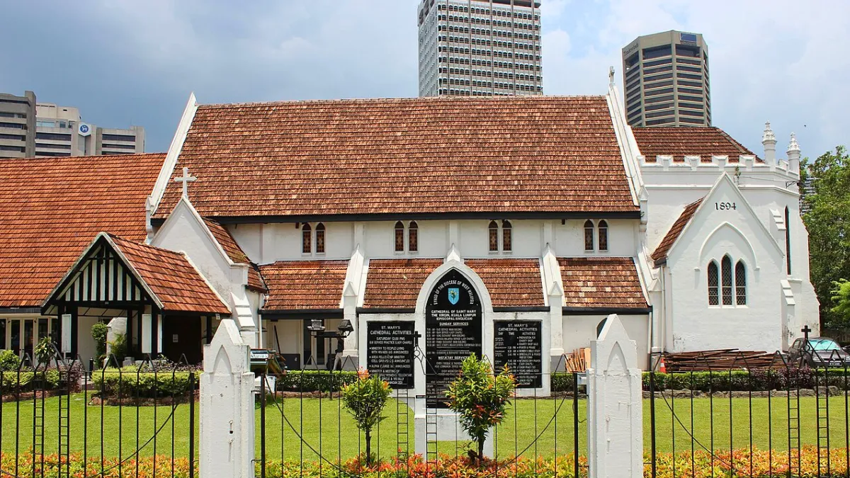 St. Mary’s Cathedral in Kuala Lumpur with a red-tiled roof and city skyscrapers behind it