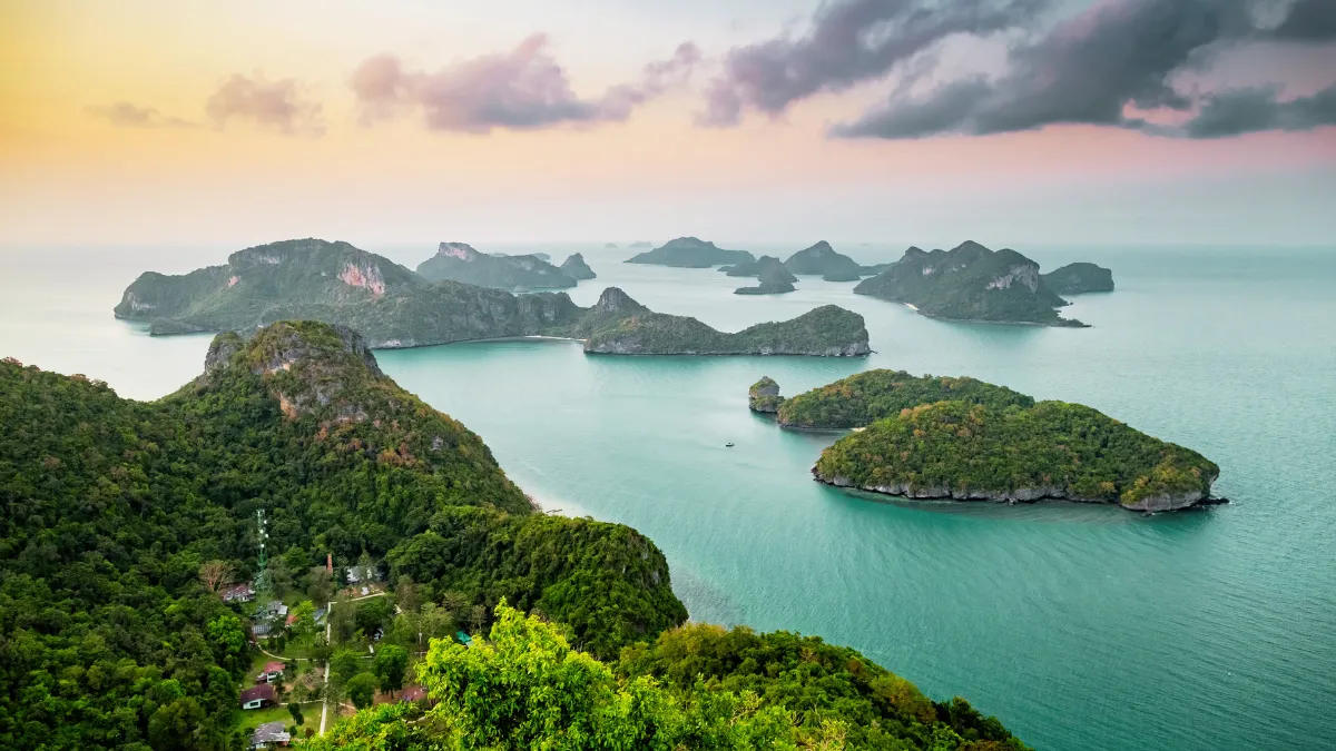 Aerial view of green tropical islands in turquoise water at sunset