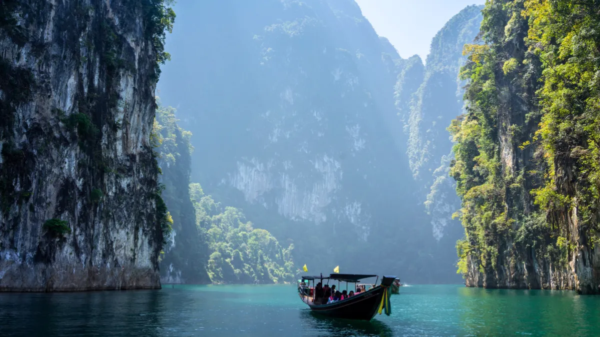 Boats heading to floating villas in Cheow Lan Lake at Khao Sok National Park