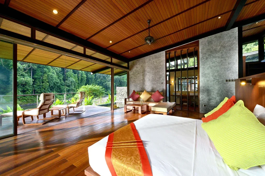 Luxury bedroom with a covered patio overlooking lush tropical forest