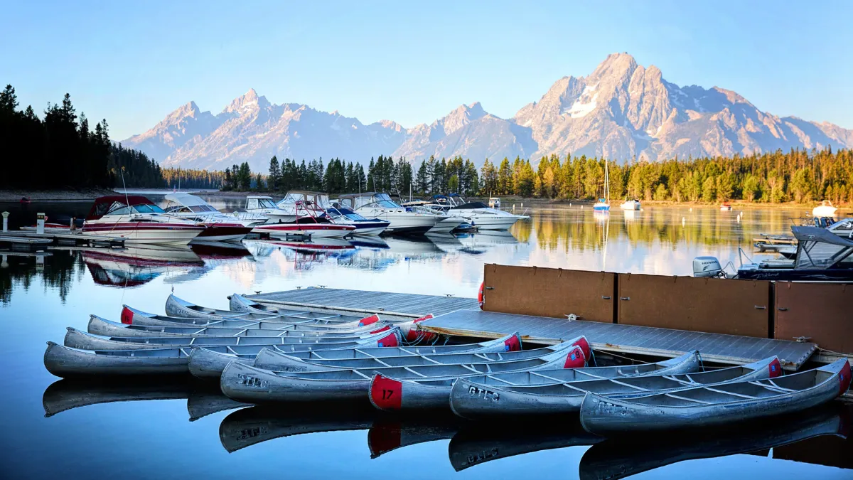 Kayaks and boats beneath the mountains in Grand Teton National Park